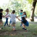 Crianças brincam alegremente ao ar livre em um parque arborizado